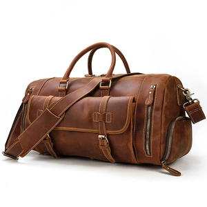 Detailed macro shot of vintage brown crazy horse leather duffle bag with side shoe compartment