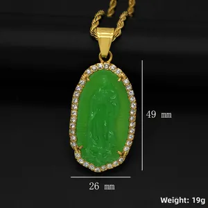 Macro shot showing dimensions of a green resin Virgin Mary pendant with sparkling crystals