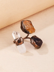 Detailed macro of vintage bronze ring featuring yellow and purple natural crystal stones