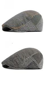 Close-up of green and dark grey herringbone wool beret hats with detailed texture