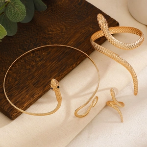 Detailed view of golden snake jewelry set with realistic scales and gemstone eyes