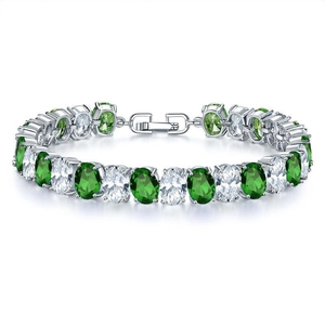 Macro view of silver bracelet with green and white oval crystals and fold-over clasp