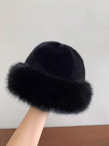 Detailed close-up of soft black faux fur texture on a thick winter bucket hat