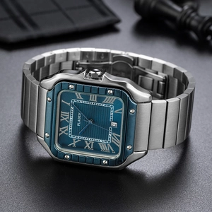 Macro detail of square blue dial with Roman numerals and date window on steel watch
