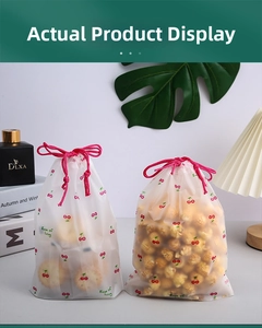 Detail of frosted cherry print drawstring storage bags showing translucent texture and red cord