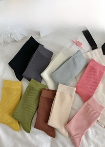 Vertical ribbed texture detail on various colorful mid-calf socks for women