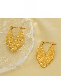 Detail of 18K gold vacuum plated earrings with hammered texture and V-shape design