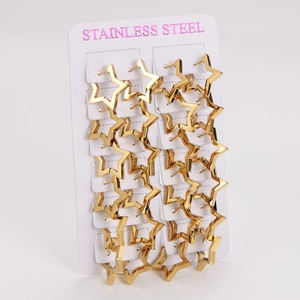 Close-up of golden star-shaped earrings made of stainless steel on a white display