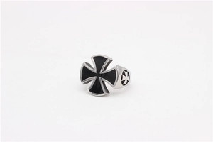 Macro view of vintage stainless steel biker ring with black iron cross relief detail