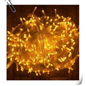 Warm yellow LED string lights for outdoor holiday decor on a transparent wire