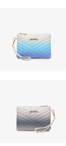 Detail view of quilted rainbow gradient wristlet clutches with metal logo and wrist strap