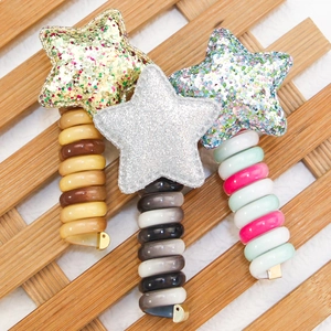 Star-shaped spiral hair ties in gold, silver, and colorful sequins with elastic bands