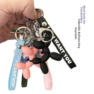 Detailed view of colorful balloon dog keychains with lobster clasps and printed wrist straps