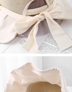 Detail of beige straw sun hat showing woven texture and adjustable bow tie on the back