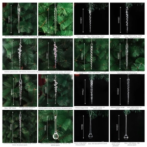 Detail of assorted clear acrylic Christmas icicle pendants with snow and bell accents