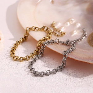 Detail of 14K gold and silver plated wheat chain bracelets on pearl shell