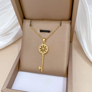 Luxury gold sunflower key necklace with crystals in a premium beige jewelry gift box