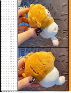 Close-up of yellow plush cat keychain with squeak function and metal buckle
