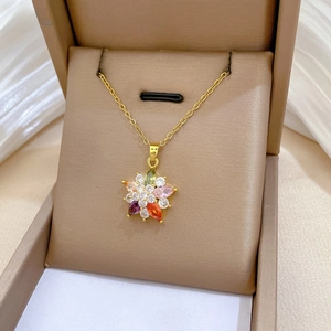 Macro view of colorful floral crystal pendant on a delicate gold titanium steel chain