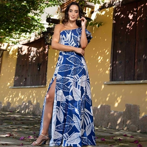 Detail of one-shoulder floral resort dress with tropical leaf print and side high slit