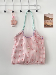 Pink checkered canvas tote bag with red bow prints and green gingham rope handles