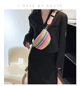 Close-up of colorful striped woven belt bag with wide strap and gold hardware