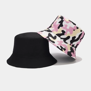 Detail of camouflage and black bucket hats showing durable stitching and canvas texture