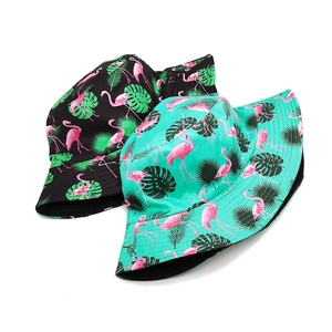 Double-sided tropical print bucket hat featuring pink flamingo and green leaf patterns