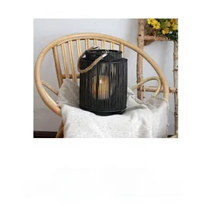 Detail of Nordic woven black wood lantern with hemp rope handle and warm LED lighting