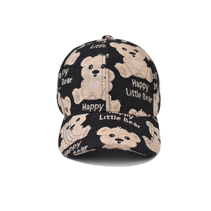 Detailed close-up of cartoon bear prints and Happy Little Bear text on black cotton cap