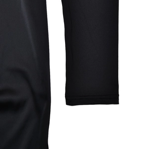 Close-up of black dress sleeve cuff showing fabric texture and stitching details
