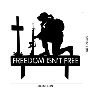 Detail of kneeling soldier silhouette metal garden stake with Freedom Isn't Free text