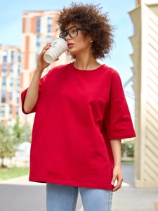 Street style άποψη γυναίκας που φοράει κόκκινο oversized βαμβακερό μπλουζάκι