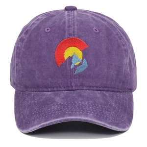 Detailed embroidery on purple washed cotton baseball cap with vintage distressed texture
