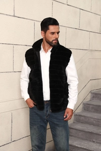 Detail of men's black faux fur vest showing striped texture and metallic zipper closure