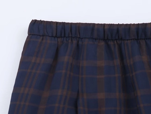 Close-up of the elastic waistband and woven texture on these blue plaid checkered pants