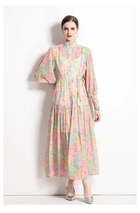 Close-up of lantern sleeves and tassel drawstring waist on a floral patchwork dress