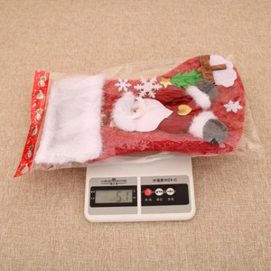 Close-up of a festive plush Christmas stocking with Santa Claus design weighing 51g