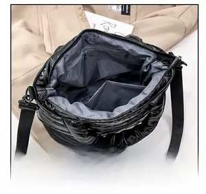 Detail view of the quilted padded bag interior with grey lining and zipper pocket