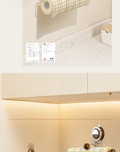 Detail of wall-mounted metal paper towel holder with wooden finial for kitchen organization