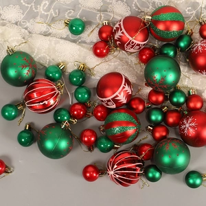Festive red and green Christmas ornaments with snowflake patterns and matte glitter finishes