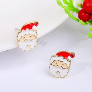 Macro shot of Santa Claus stud earrings with red rhinestones and gold-toned metal details