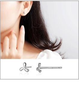 Detailed view of S999 sterling silver clover stud earring with polished finish and logo
