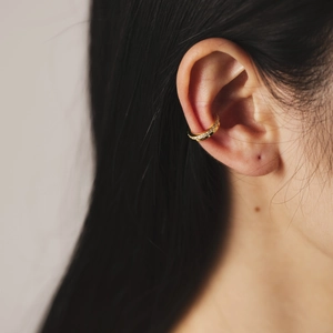 Elegant gold S925 silver ear cuff with sparkling zircon inlay for women shown on model