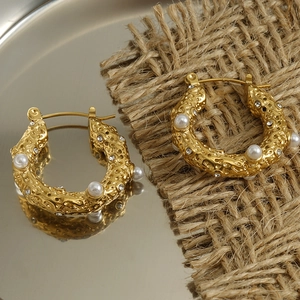 Detail of 18k gold hammer textured hoop earrings with pearl and crystal accents
