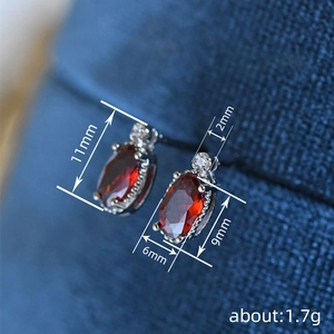 French vintage style red oval gemstone stud earrings with silver lace setting and tiny diamond