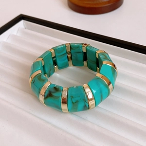 Detail of vintage gold-plated stretch bracelet with turquoise marble resin blocks