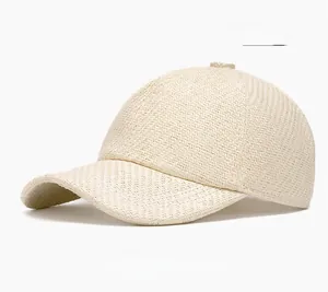 Detailed close-up of beige straw woven baseball cap with breathable texture and vintage style