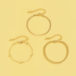 Detailed set of three golden snake and curb chain bracelets with lobster clasps