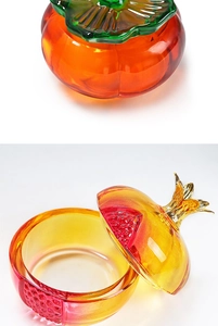 Detail of pomegranate glass nail art cup with orange gradient and golden leaf lid